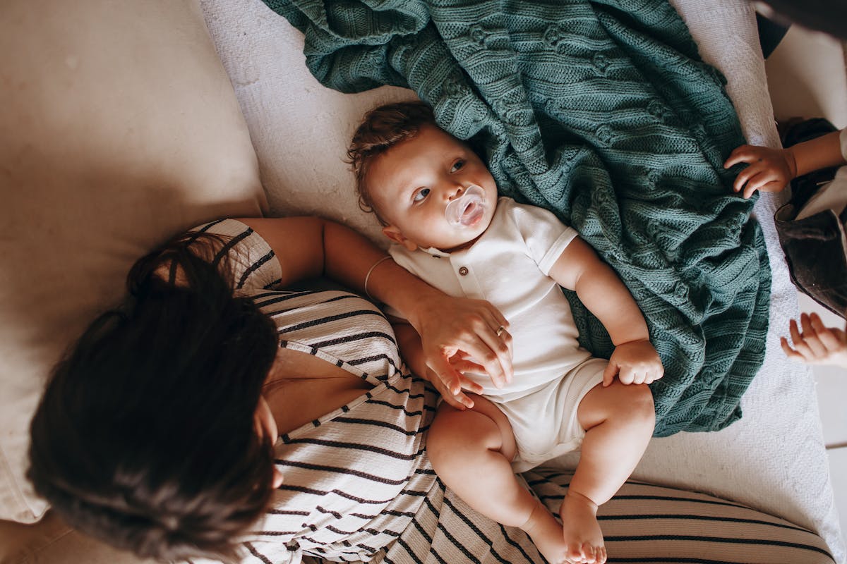 Woman holding a baby while looking at a document