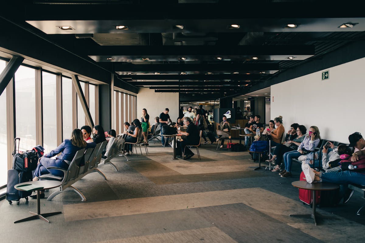 Travelers seated in an airport waiting area